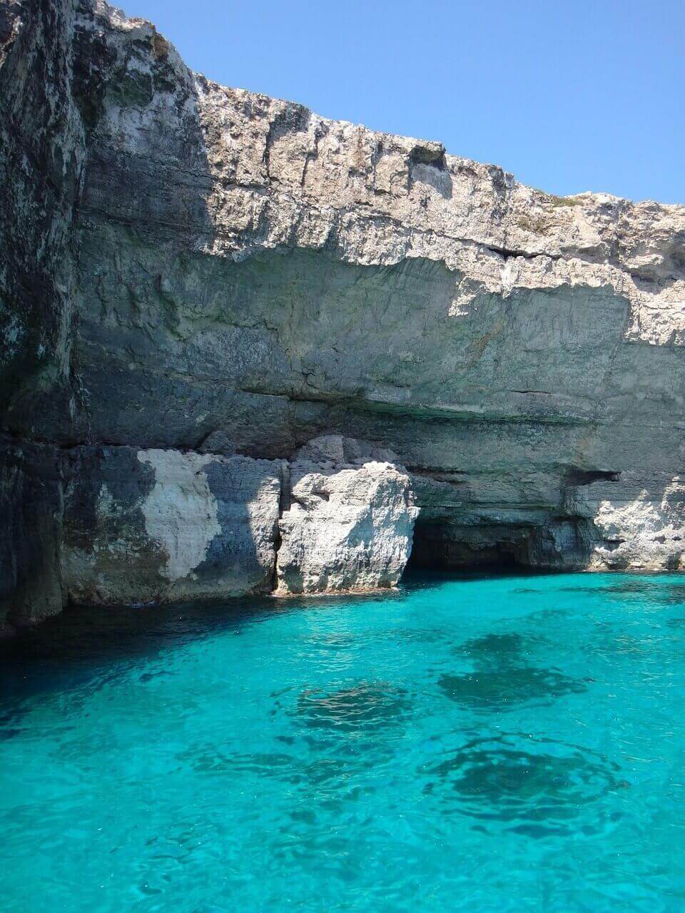 Blue Lagoon Malta with crystal-clear turquoise water and limestone cliffs on Comino Island