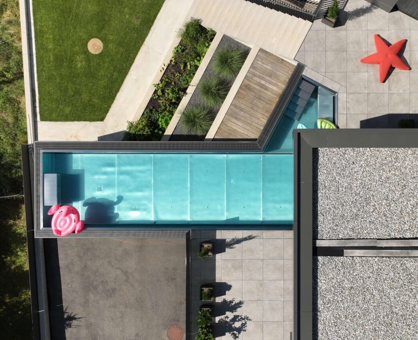 Aerial drone shot of a modern swimming pool and terrace from above