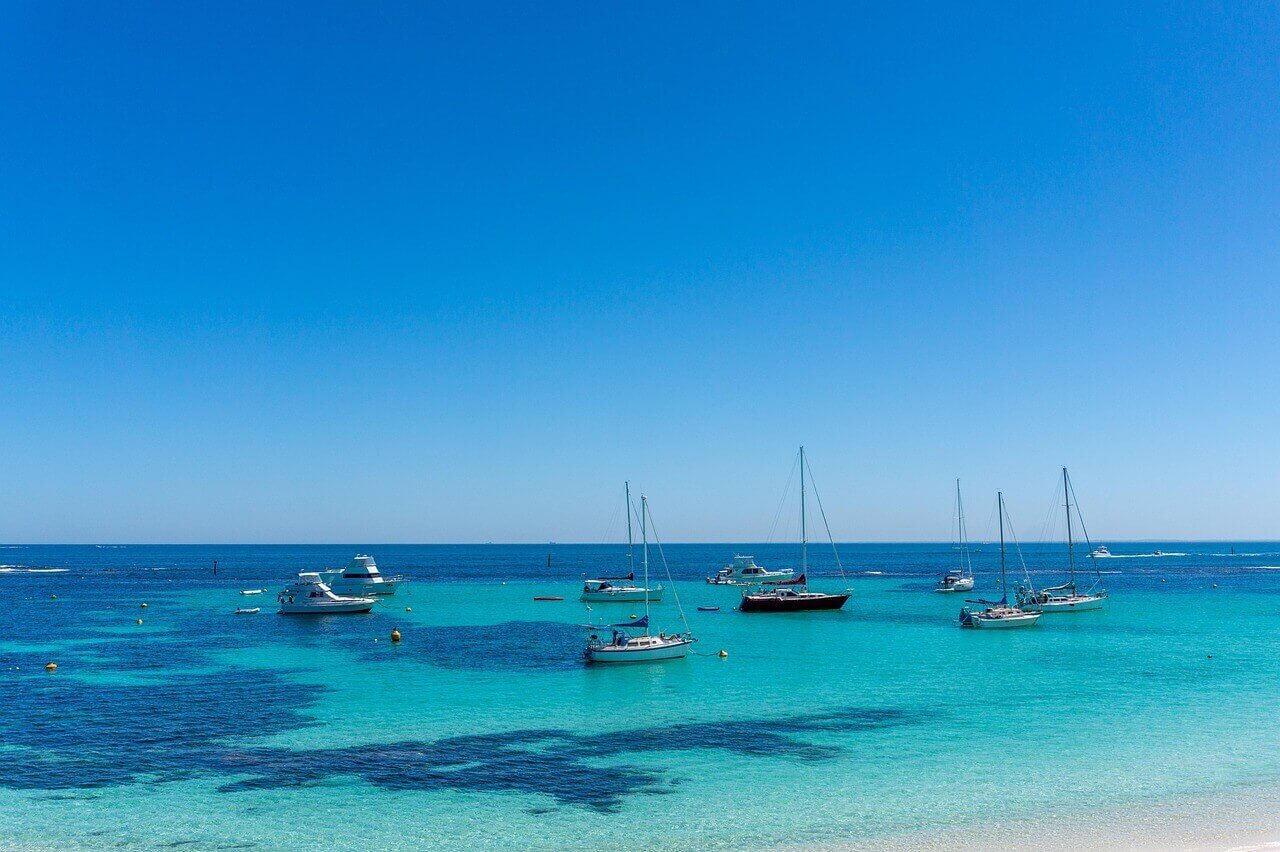 Turquoise waters and boats off the coast of Rottnest Island near Perth, Western Australia